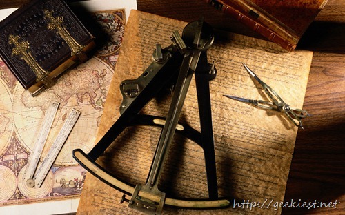 Still life of charts, books, and various tools used in map making